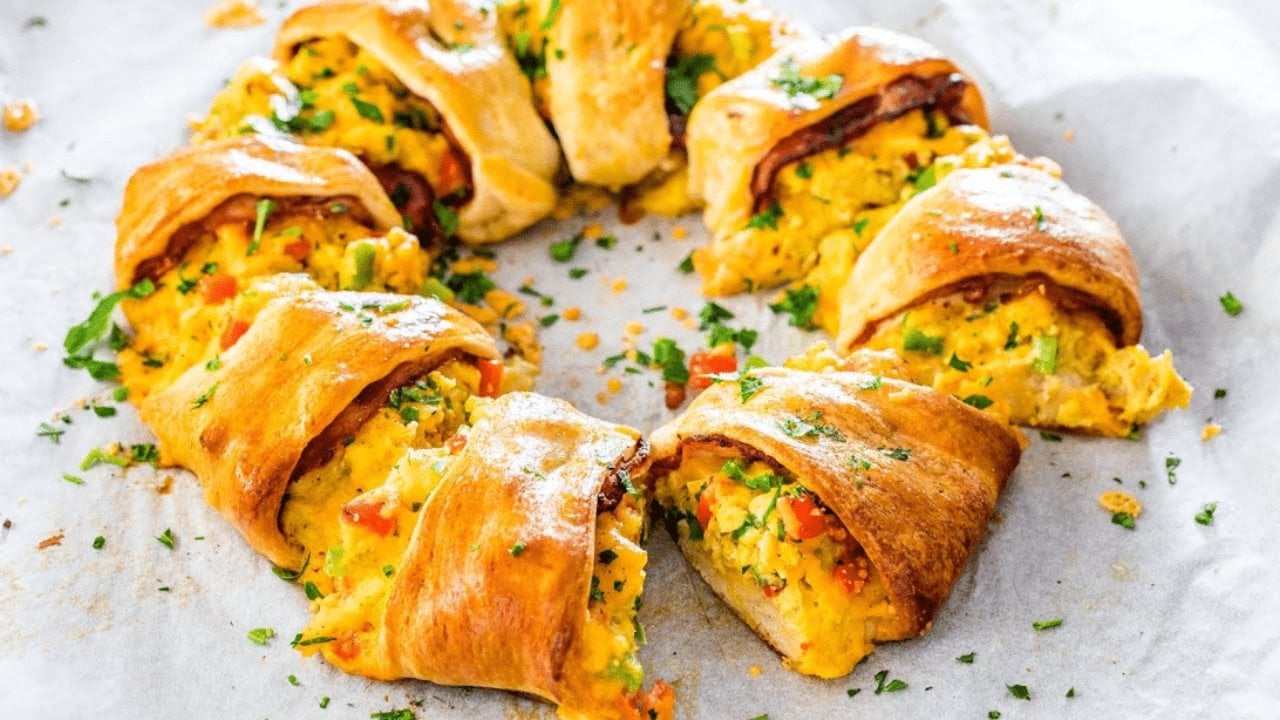 Crescent Bacon Breakfast Ring Recipe Crescent bacon breakfast ring filled with scrambled eggs, bell pepper, bacon and cheddar on a sheet pan