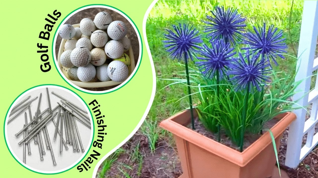 Purple faux allium flowers made from golf balls and nails on green stems, standing in a terracotta planter in a garden