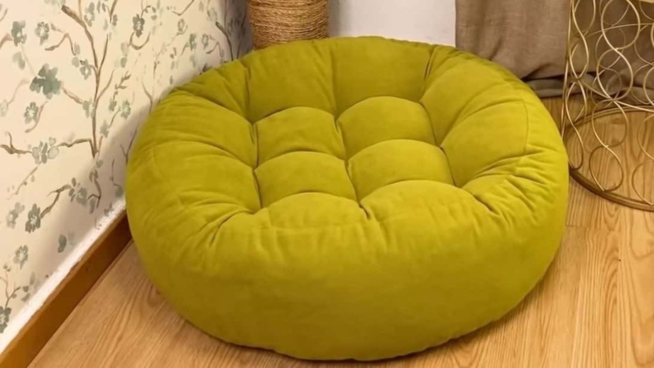 DIY Floor Pouf Cushion, an Easy Sewing Tutorial Round chartreuse velvet DIY floor pouf cushion with deep button tufting, on a wood floor in a papered corner
