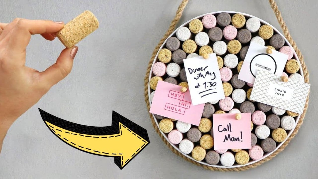 Easy DIY wine cork board, a round tray packed with pink, white and gray painted corks holding notes, hung on rope