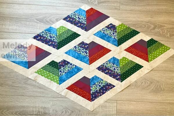 Finished Easy Geometric Charm Quilt, a completed DIY project