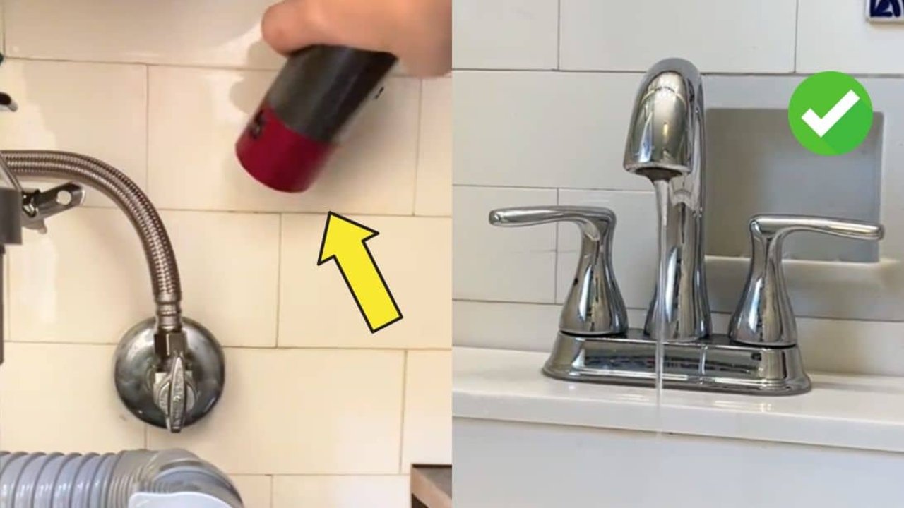 Easy hack to fix a frozen pipe, a hand aiming a hair dryer along an exposed copper water pipe under a sink in a cold cupboard