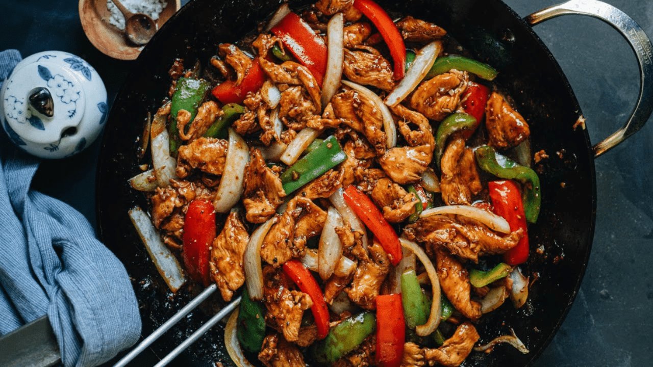 Easy Skillet Black Pepper Chicken Skillet black pepper chicken with bell peppers and onion in a glossy dark sauce over rice, a dinner for one