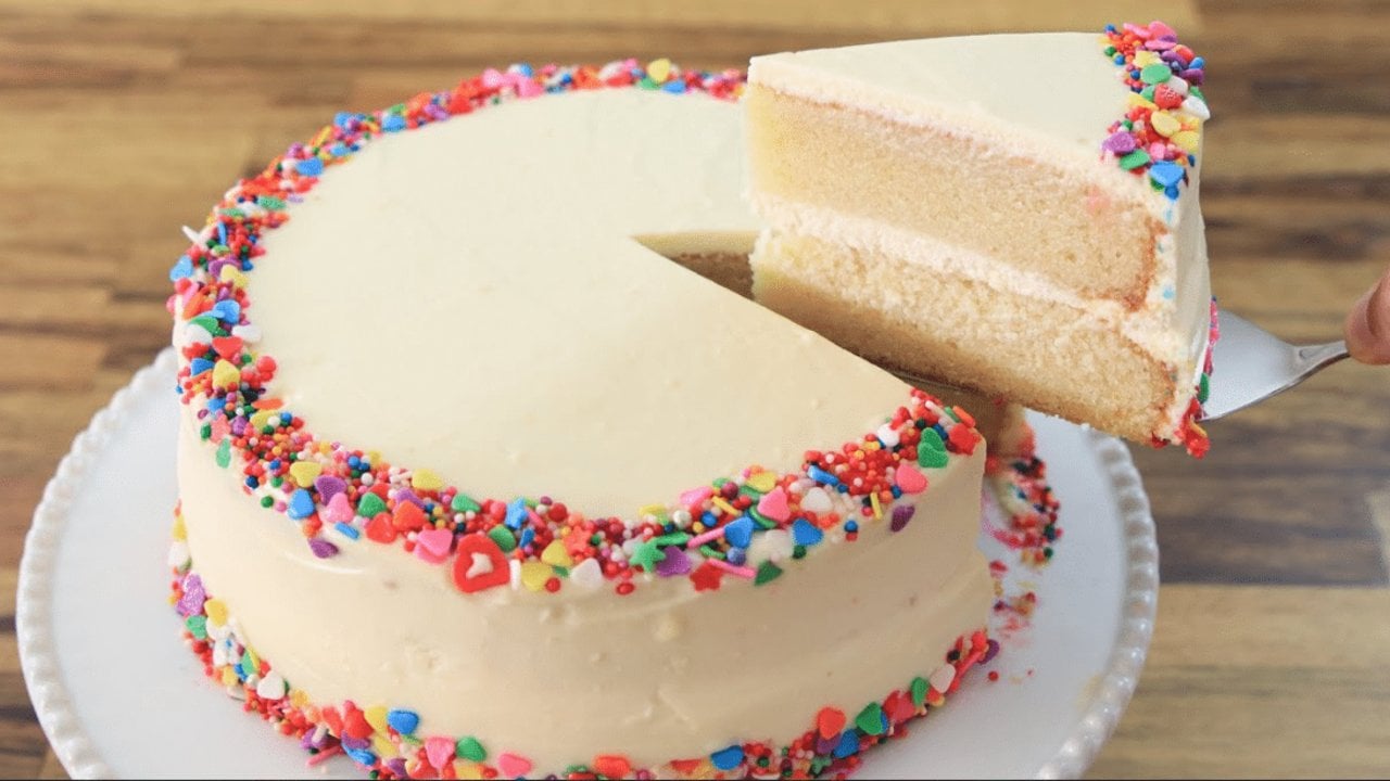 Classic vanilla birthday cake with cream cheese buttercream frosting and confetti sprinkles on top recipe for a celebration