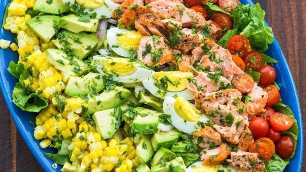 Healthy Cobb Seafood Salmon Salad With Dressing, homemade and freshly served