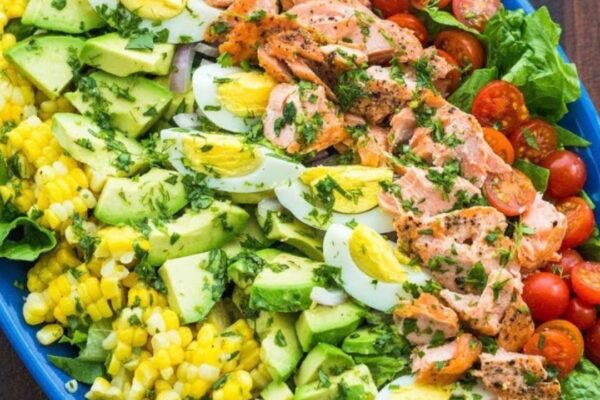 Healthy Cobb Seafood Salmon Salad With Dressing, homemade and freshly served
