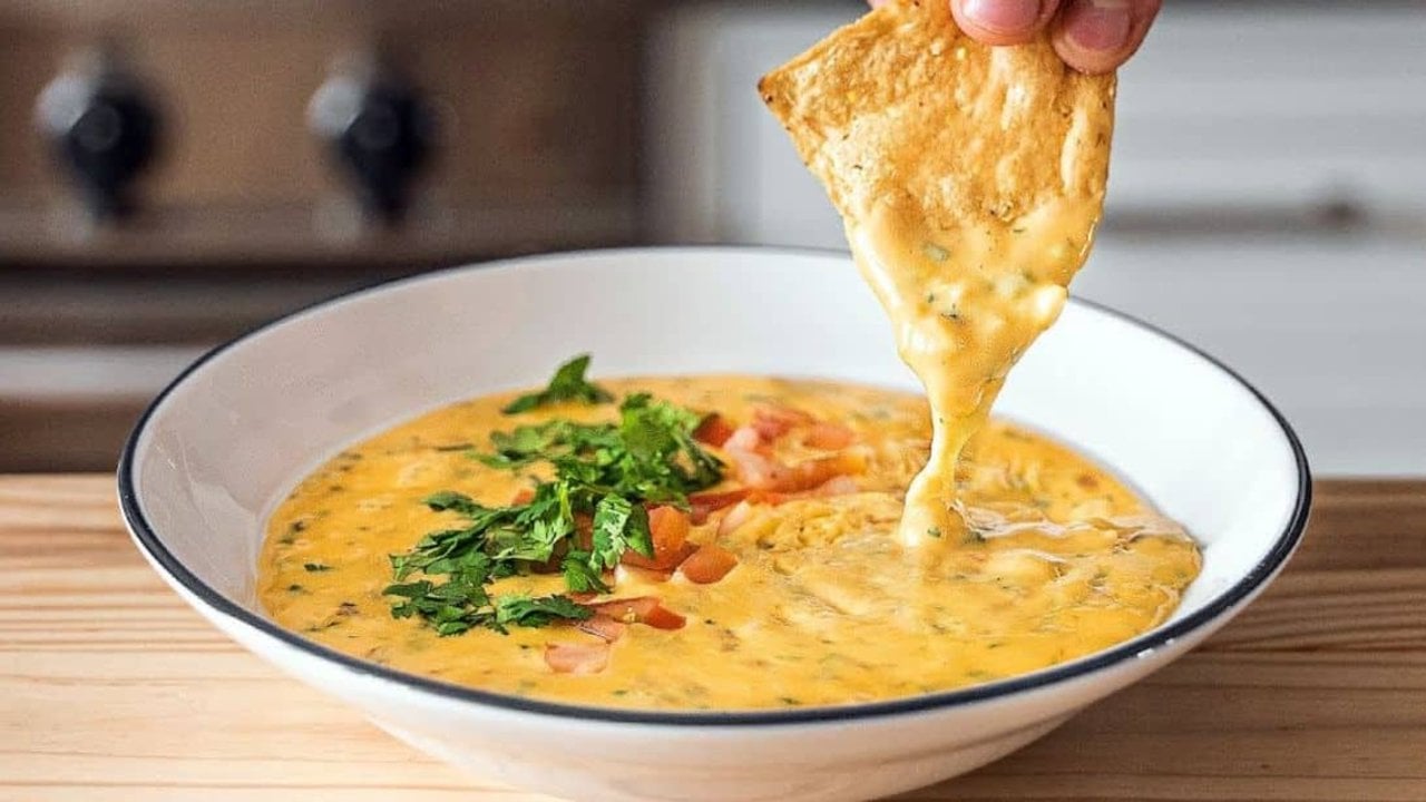 Cheesiest Homemade Texas Queso Recipe Cheesiest homemade Texas queso, a smooth melted cheese dip with diced jalapenos and tomato in a warm bowl