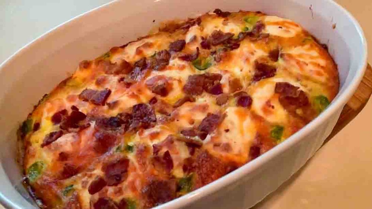 Keto Cheeseburger Casserole Recipe Keto cheeseburger casserole baked golden with bacon and pickle pieces on top in a white oval baking dish