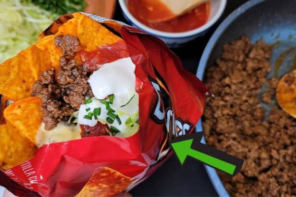 Loaded Doritos and Frito Pie With Nacho Cheese Sauce, homemade and freshly served