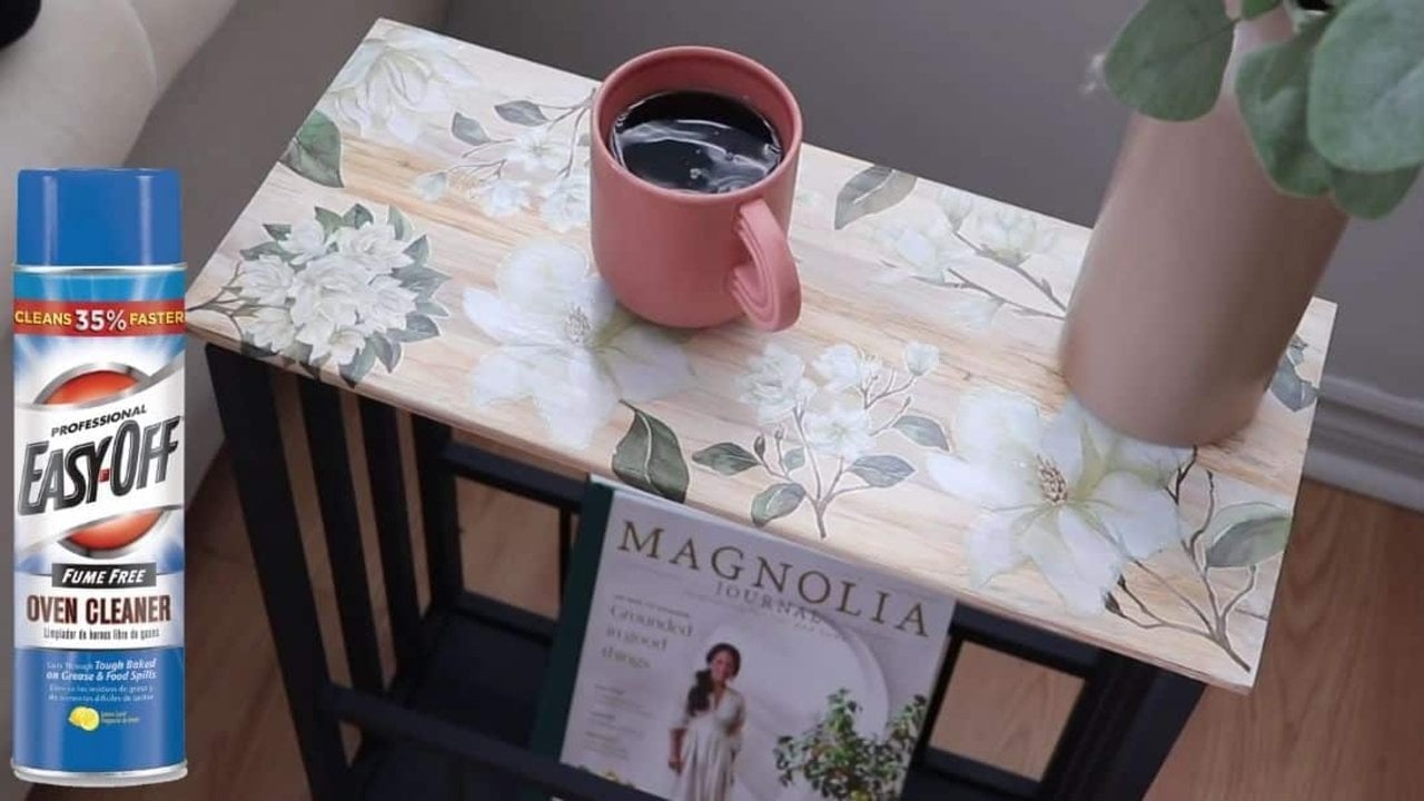 Low-cost DIY table makeover, a whitewashed wood side table top with white magnolia transfers, a pink mug and a magazine