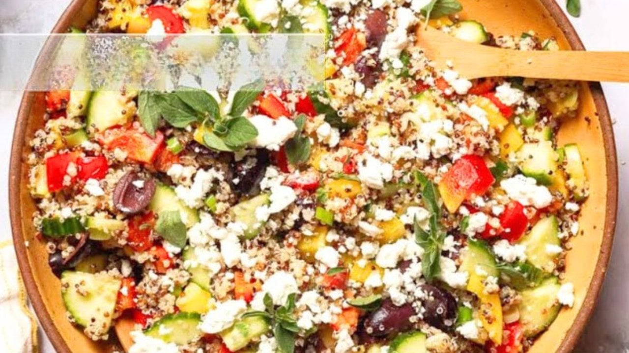 Mediterranean quinoa salad with chopped vegetables, scallions and a lemon oregano olive oil dressing in a bowl