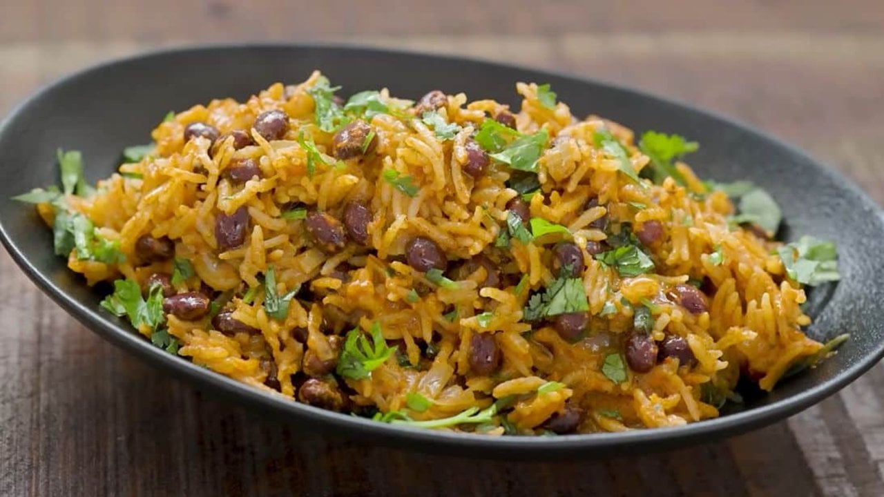 One pot rice and beans with black beans, basmati rice and coconut milk finished with fresh cilantro ready to serve at home