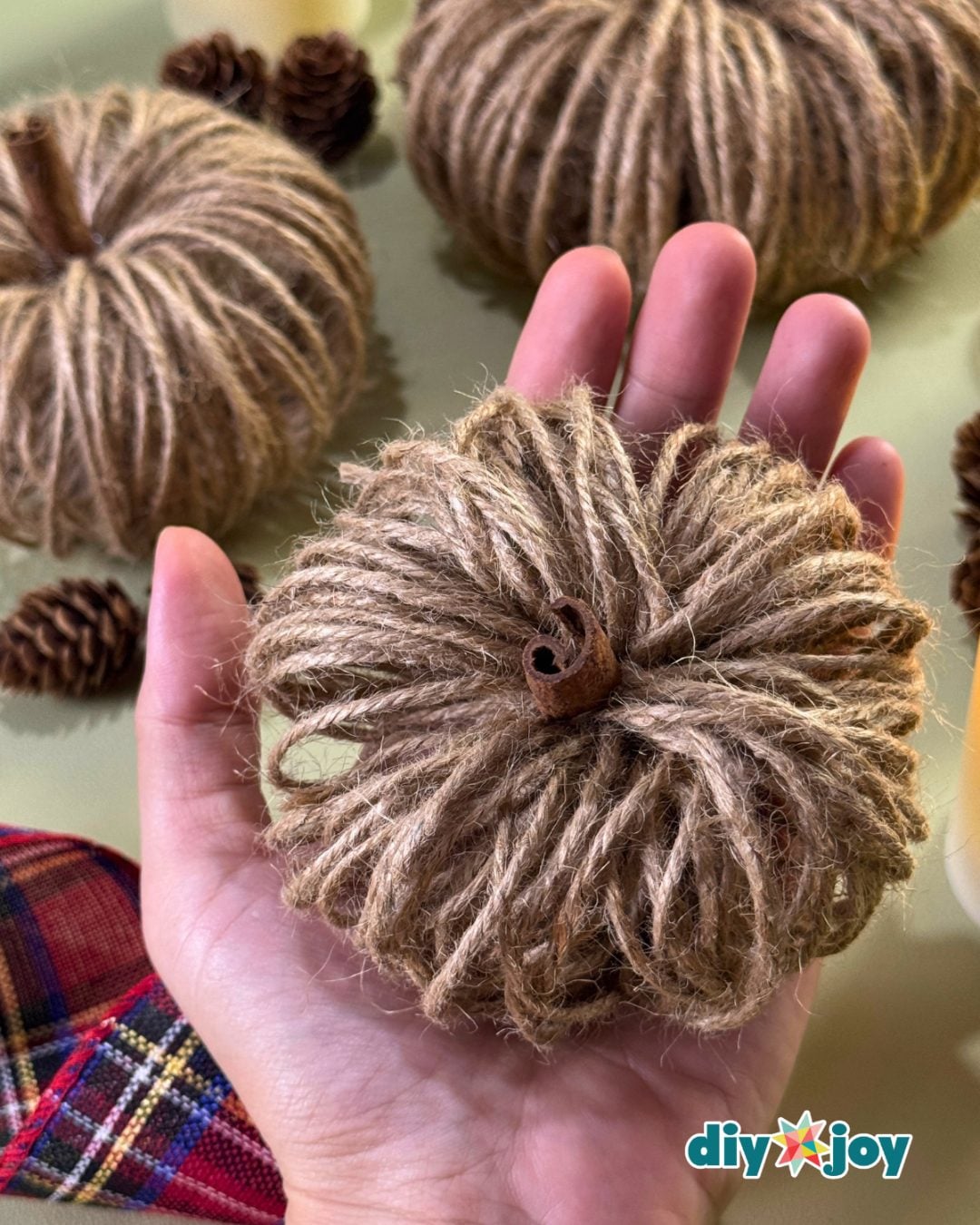 Pumpkin crafts - handmade twine pumpkin styled on a rustic wood table as DIY fall decor