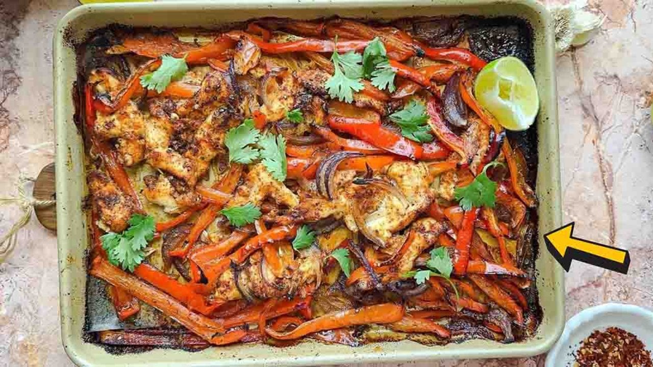 Sheet pan fajitas with chicken tenders, sliced bell peppers and onions roasted in one single layer ready to serve at home