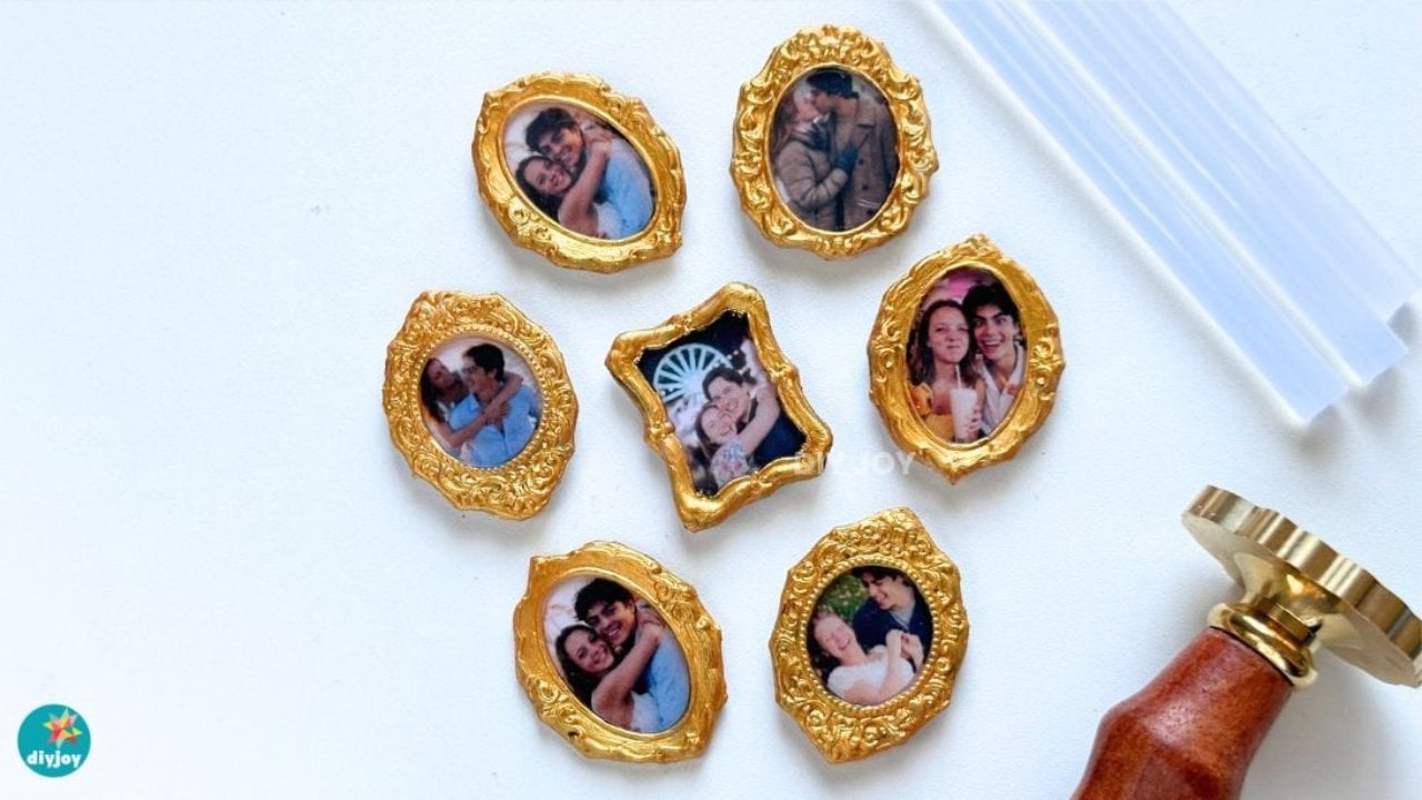 Mini hot glue photo frame magnets, seven tiny gold oval and scalloped frames with couple photos beside a wax seal stamp