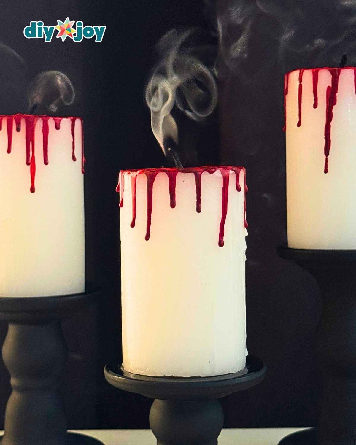 DIY bloody candle for Halloween with red crayon blood drips running down a white pillar candle