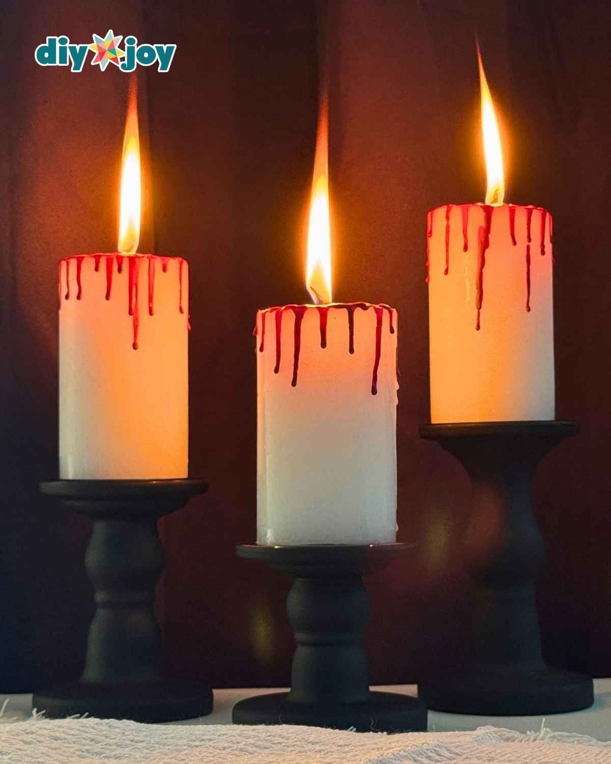 Close up of a bloody candle showing realistic red wax blood drips made from melted crayons