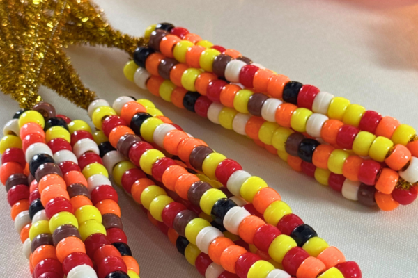 Thanksgiving Crafts - beaded Indian corn displayed with mini pumpkins