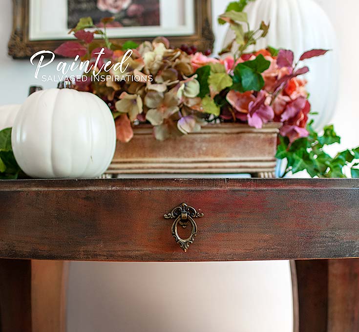 Layered fall-color paint technique on a thrifted entryway table