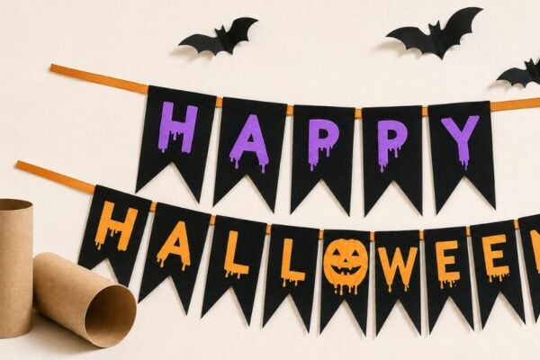 Halloween crafts - finished DIY Happy Halloween banner made from toilet paper rolls hanging on a wall