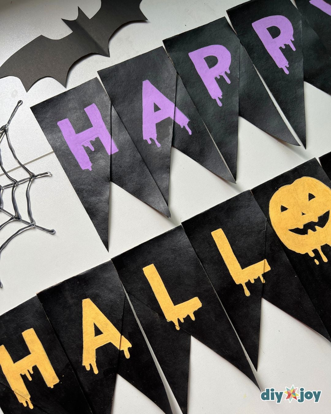 Happy Halloween banner - the full bunting with the pumpkin letter O strung on ribbon