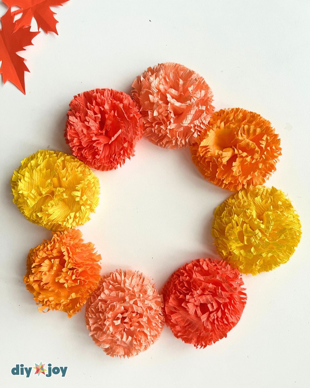 Easy Crafts - crepe paper marigold flowers arranged in a fall wreath shape