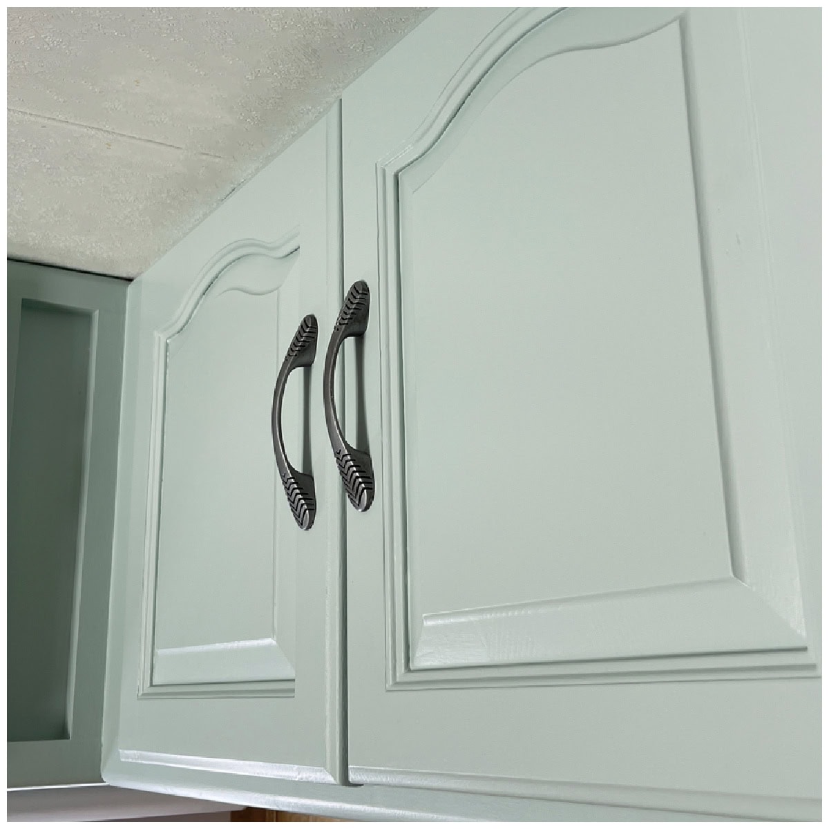 Oak cabinets painted with a smooth durable finish, a furniture refinishing technique