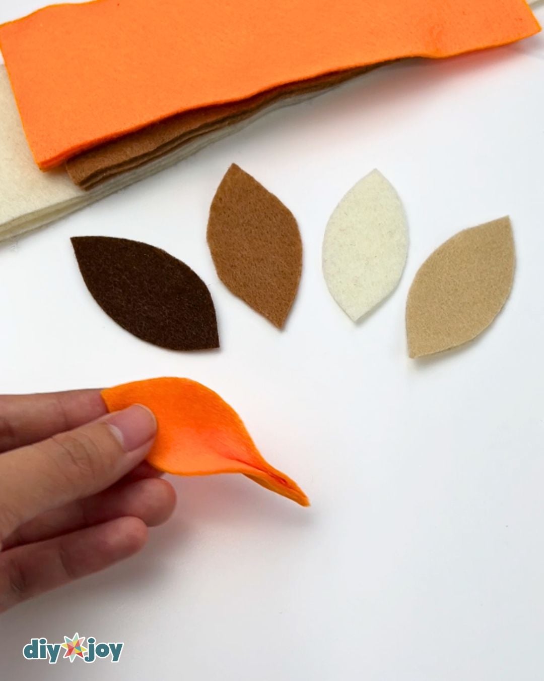 Felt crafts - folding and pinching a cut felt leaf beside sorted leaf shapes