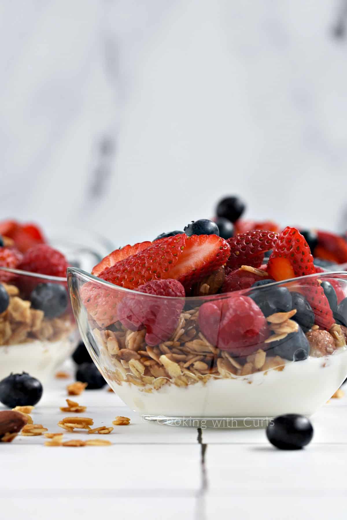 Greek yogurt parfait layered with fresh mixed berries and granola