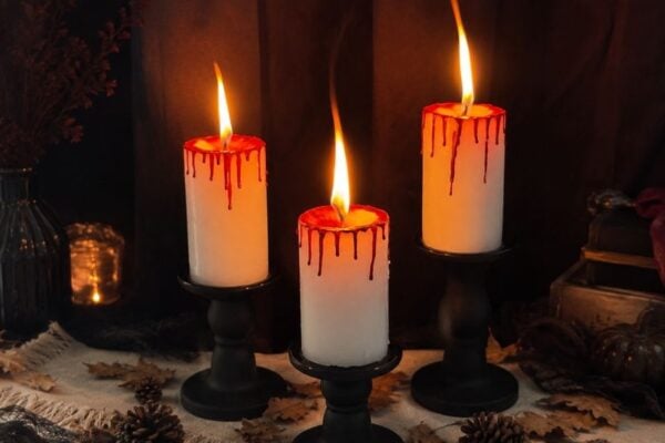 Bloody candles made with red crayons, a spooky DIY Halloween candle with realistic dripping blood wax