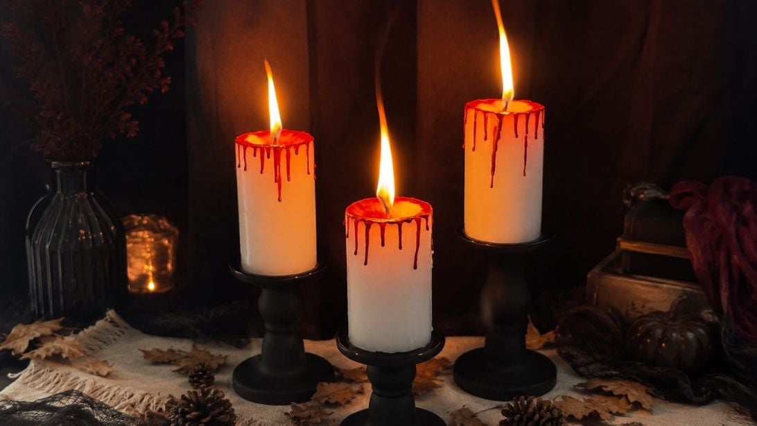 Bloody candles made with red crayons, a spooky DIY Halloween candle with realistic dripping blood wax