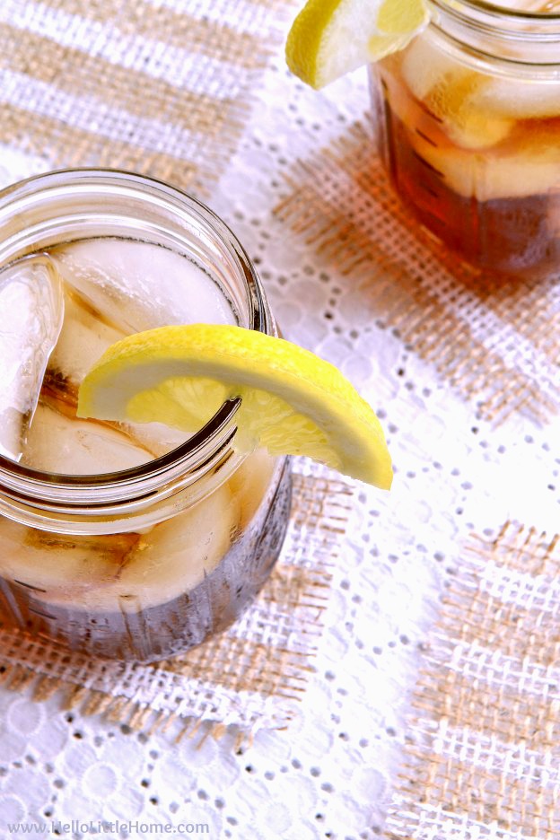 Striped painted burlap coasters with fringed edges under two mason jar iced teas on an outdoor table