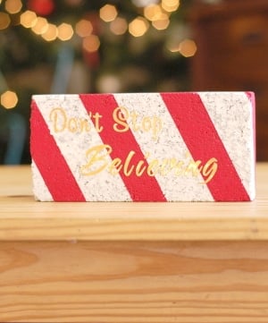Brick painted with a white base coat and crisp red candy cane stripes