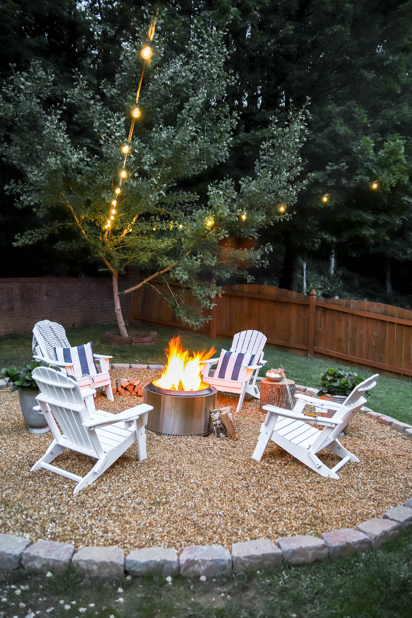 Firepit area with a pea gravel base and defined border for real outdoor living for anyone who loves this hobby