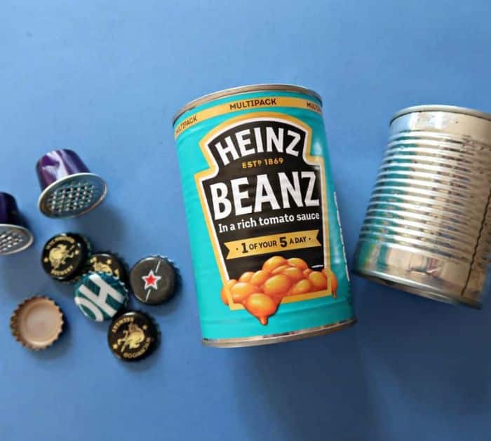 DIY recycled tin can owl craft with painted details and googly eyes, an easy outdoor garden decoration