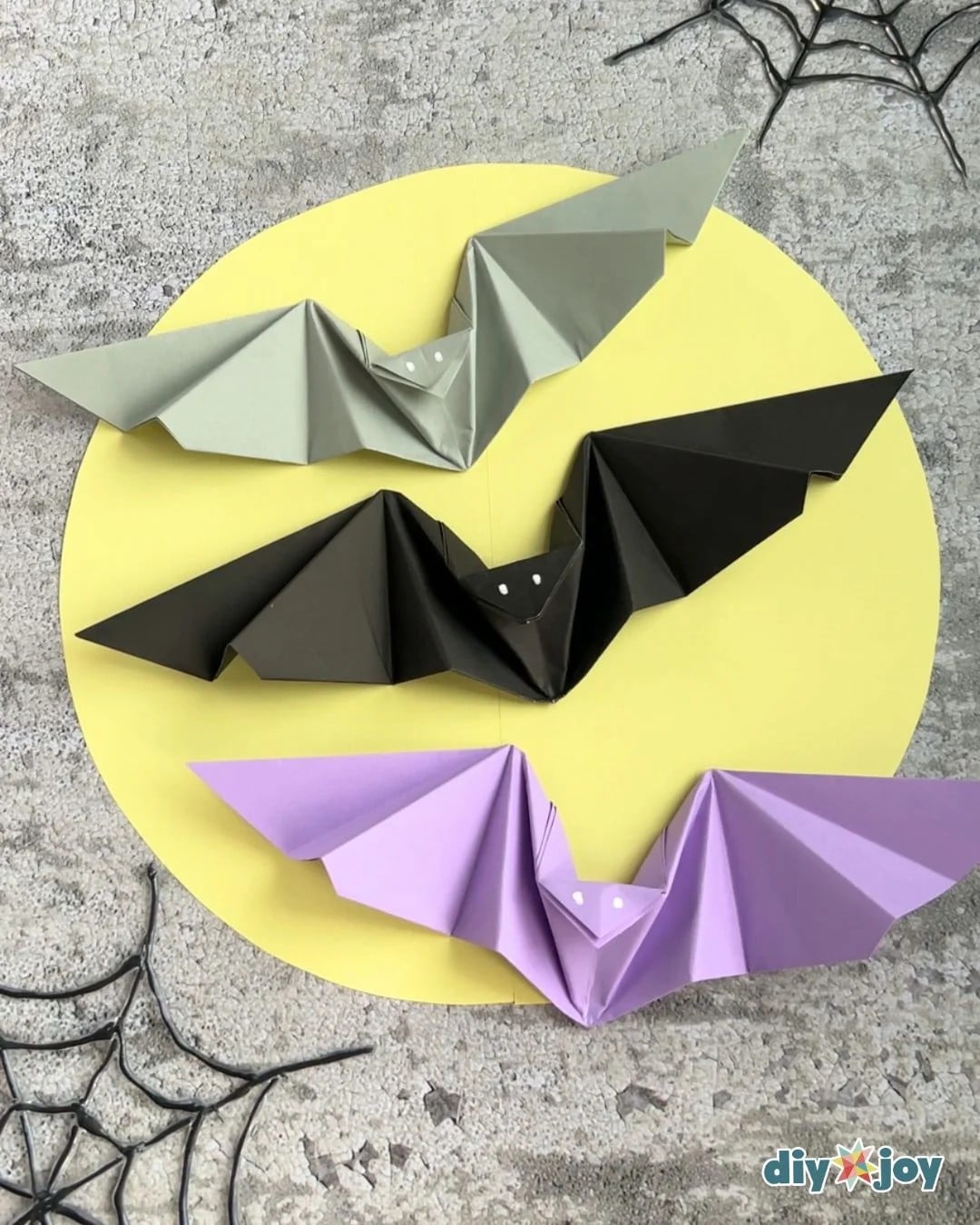 Paper bat with flapping wings held close up for Halloween