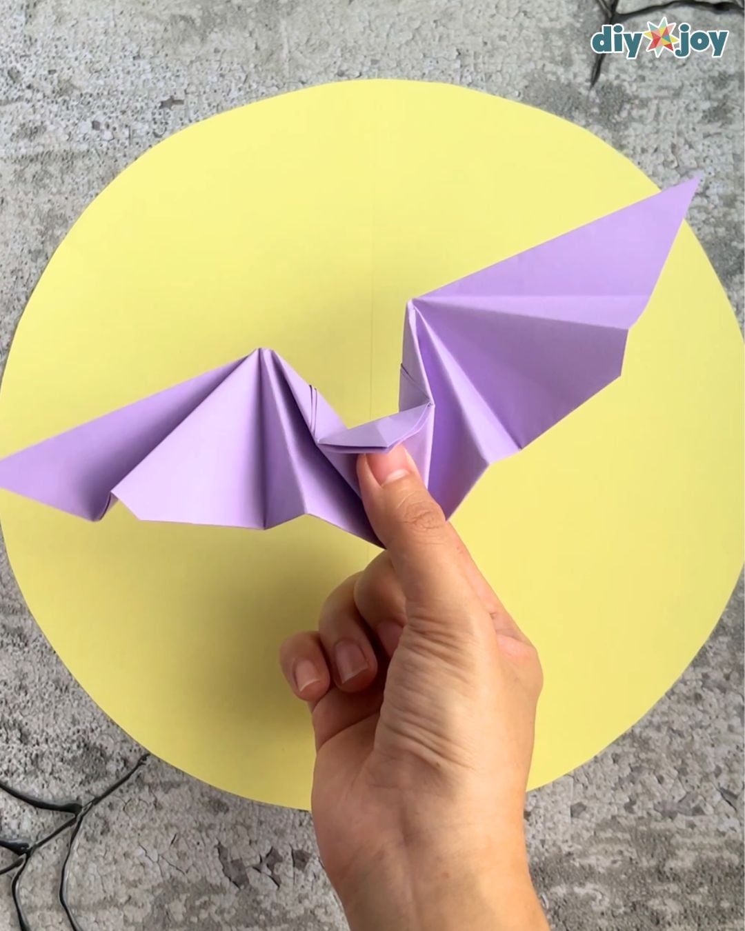 Paper bat craft step 9, shaping the folded wings