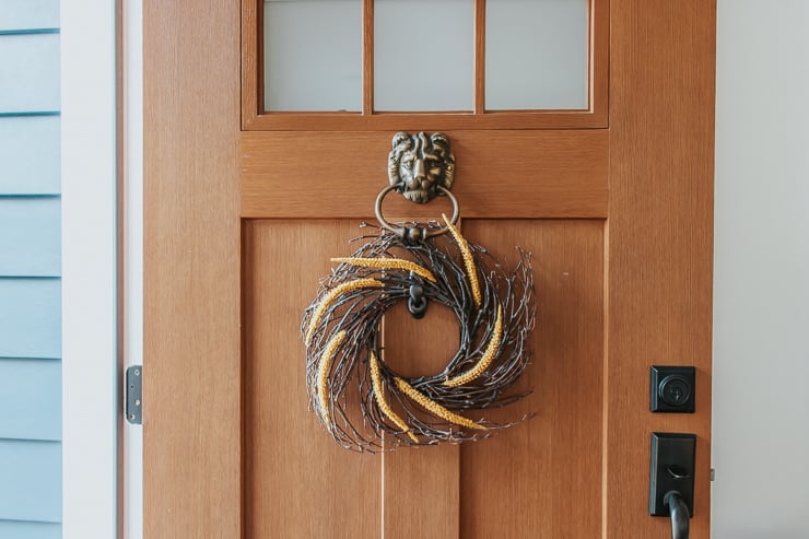 Simple autumn wreath made for under ten dollars and hung on a front door, a cheap seasonal wreath idea