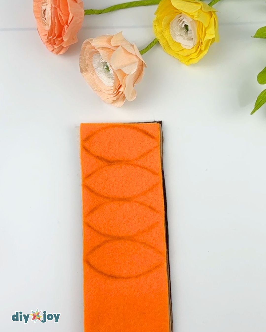 Fall wreath tutorial - felt sheets stacked and traced with a leaf pattern ready to cut
