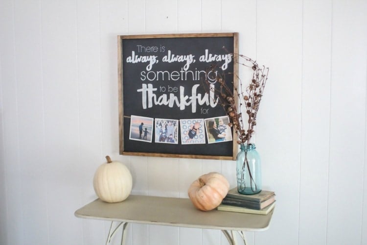 Handmade fall thankful sign with photo clips on a stained wood frame