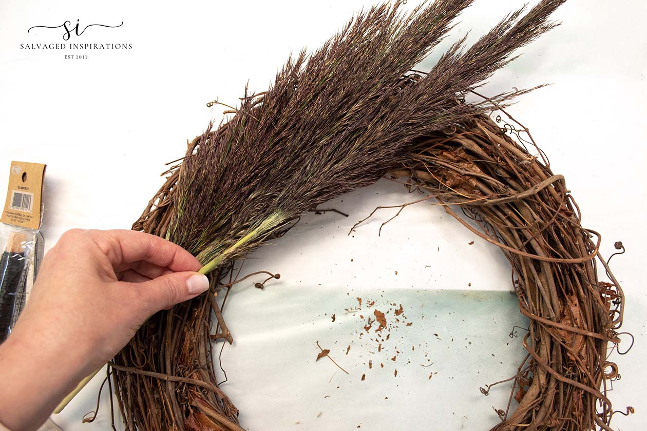 Dried grass plumes arranged on a thrifted wreath form, a soft fall wreath made from secondhand finds