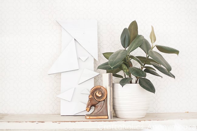 Modern triangle geometric wall art made from wood shapes and spray paint, an easy DIY bedroom wall decor idea