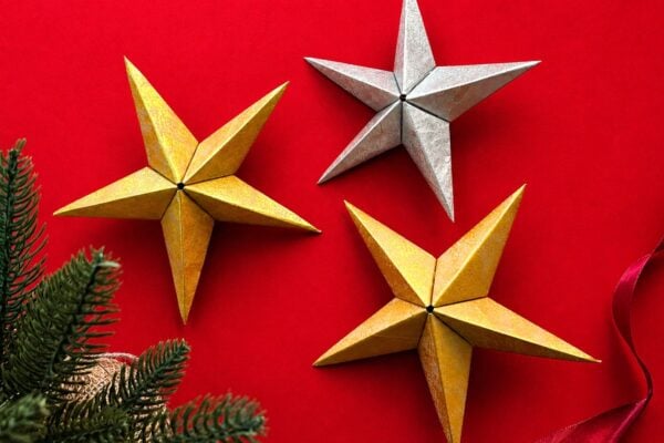 DIY paper bag star ornament - a finished 3D gold and silver Christmas star folded from painted kraft paper