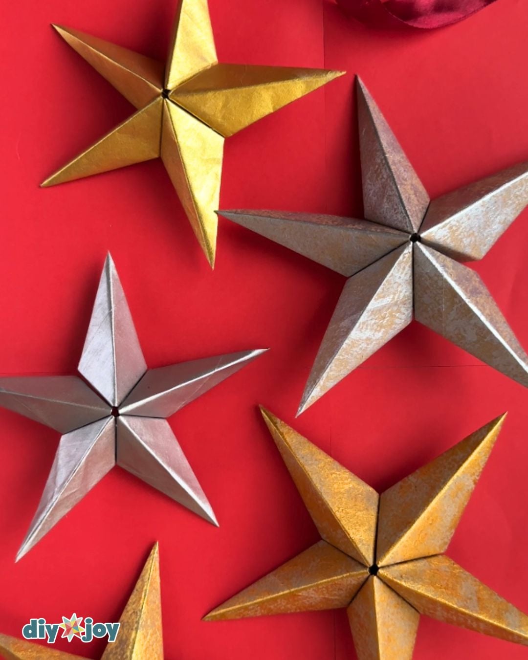 Paper bag star ornament collection - gold and silver 3D paper stars clustered together as holiday decor