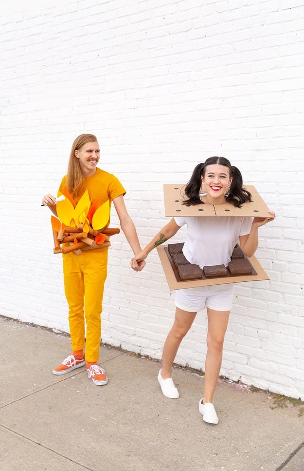 Couples Halloween costume idea, one partner as a foam campfire with a marshmallow, the other as a cardboard s'more