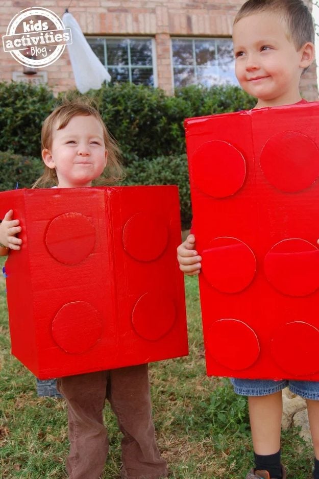 Easy Halloween costume idea, two matching Lego brick costumes made from red spray painted cardboard boxes with studs