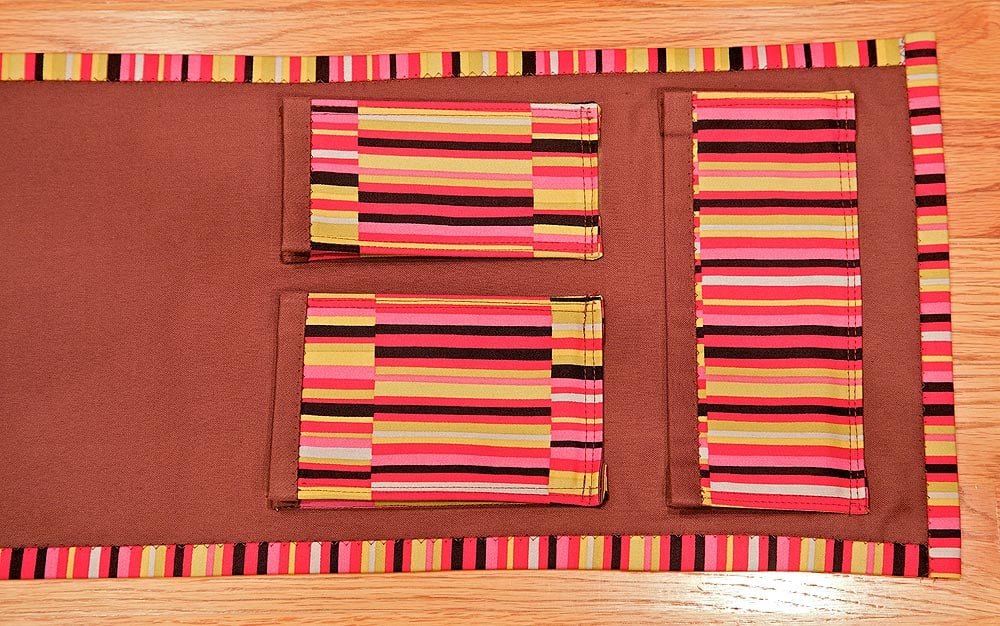 Homemade gift for mom, sewn sofa arm caddy in brown cotton with three striped pockets for remotes