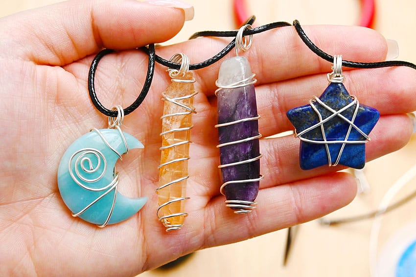 Gifts to make for mom, four wire wrapped crystal pendant necklaces including an amazonite moon, a citrine point and a lapis star