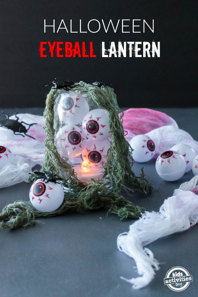Eyeball lantern glowing under green creepy cloth with Halloween Eyeball Lantern headline and Kids Activities Blog mark