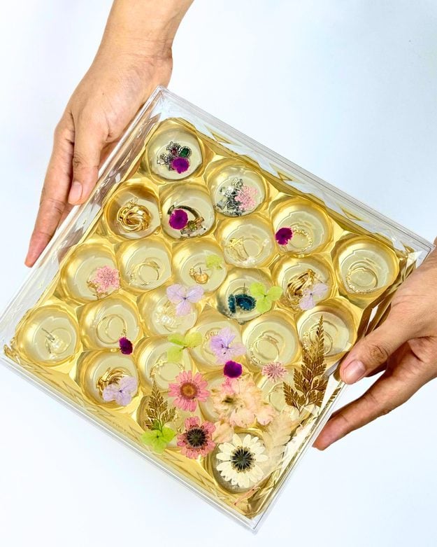 An empty gold Ferrero Rocher candy box lined and upcycled into a small jewelry organizer box, a clever handmade upcycle craft